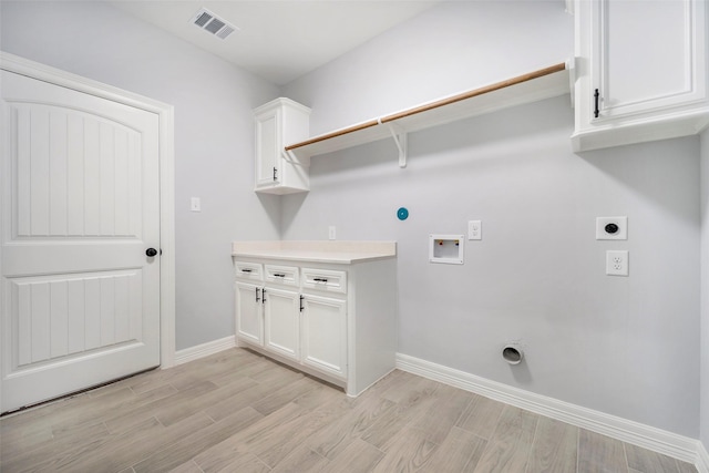 laundry area with cabinets, hookup for a washing machine, light wood-type flooring, and electric dryer hookup