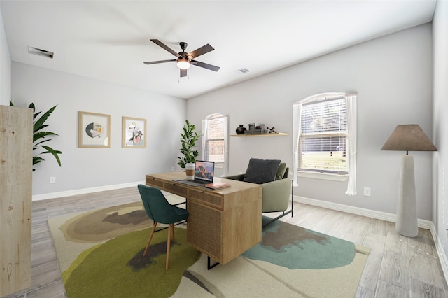 home office featuring ceiling fan and light hardwood / wood-style flooring