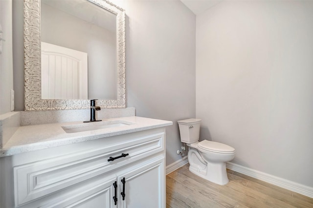 bathroom with vanity, hardwood / wood-style flooring, and toilet