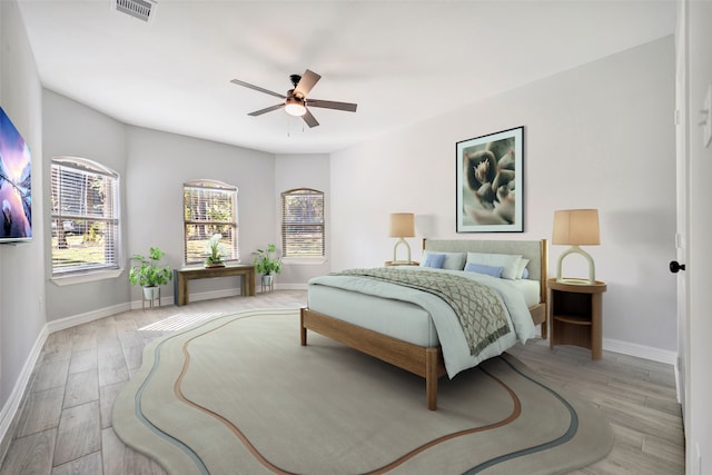 bedroom with light hardwood / wood-style flooring and ceiling fan