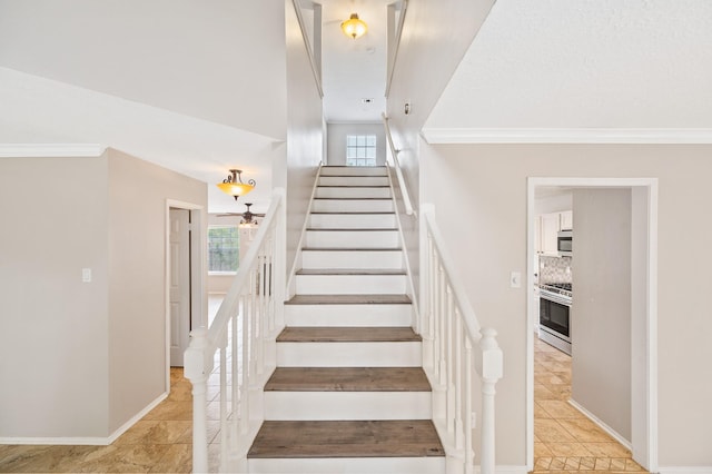 stairs featuring crown molding and a wealth of natural light