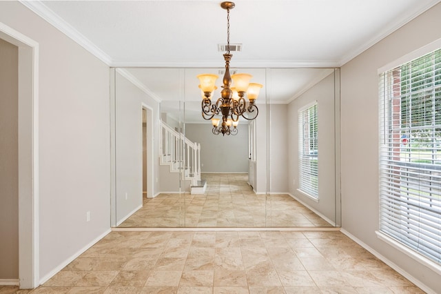 foyer with a chandelier and ornamental molding