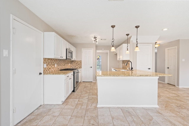 kitchen featuring white cabinets, decorative light fixtures, stainless steel appliances, and sink