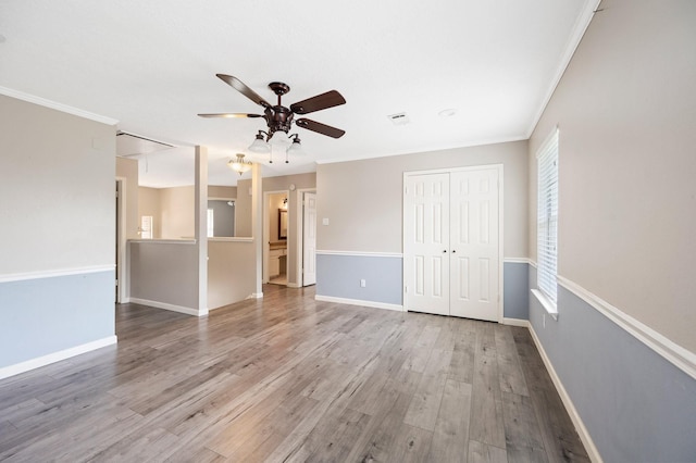 unfurnished room with crown molding, light hardwood / wood-style flooring, and ceiling fan