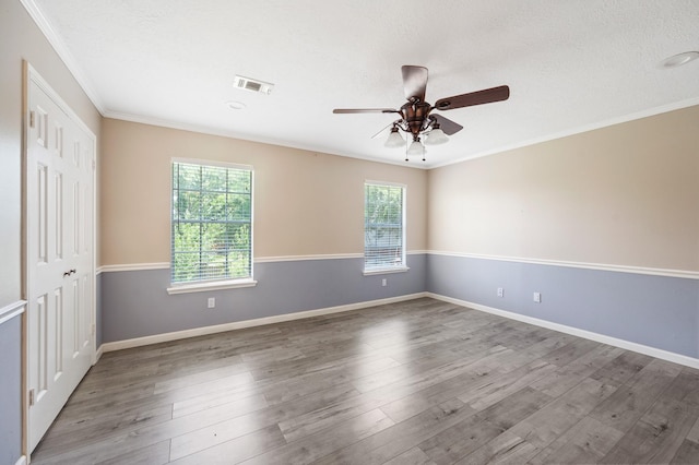 spare room featuring crown molding, ceiling fan, a textured ceiling, and hardwood / wood-style flooring