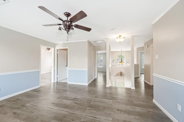 empty room featuring ceiling fan, crown molding, and hardwood / wood-style flooring