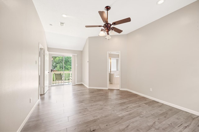 empty room featuring ceiling fan, lofted ceiling, and light wood-type flooring