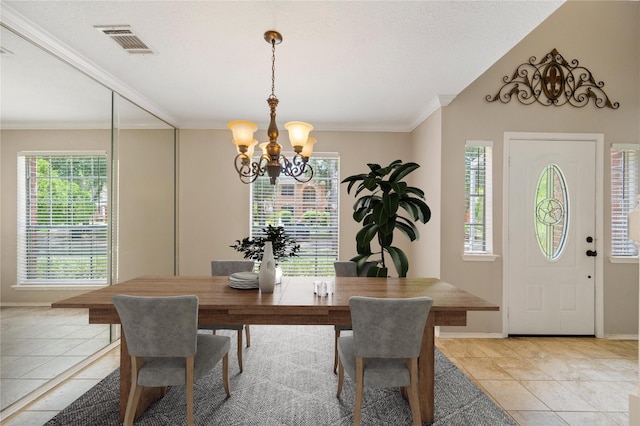 tiled dining space with ornamental molding and a chandelier