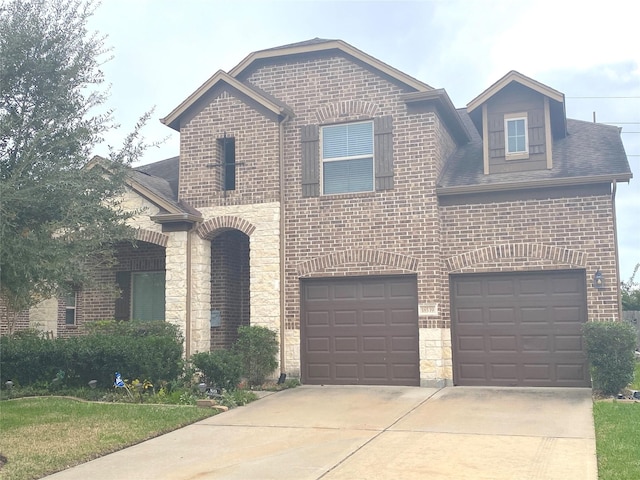 18539 Windy Knoll Way, Houston, TX 77084 - french provincial home featuring driveway, brick siding, an attached garage, stone siding, and a shingled roof