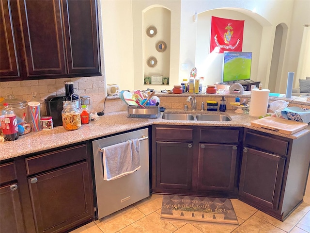 kitchen featuring dishwasher, sink, backsplash, dark brown cabinets, and light tile patterned floors