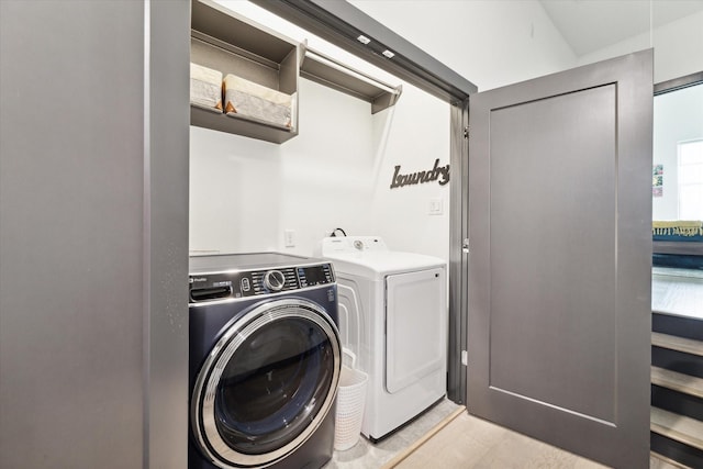 washroom with washing machine and clothes dryer