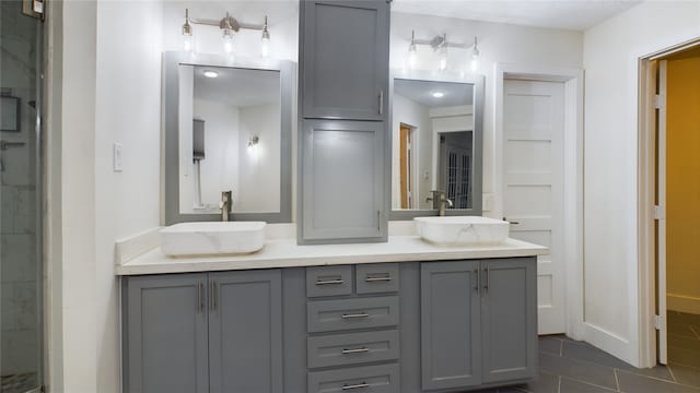 bathroom featuring tile patterned floors, vanity, and a shower with shower door