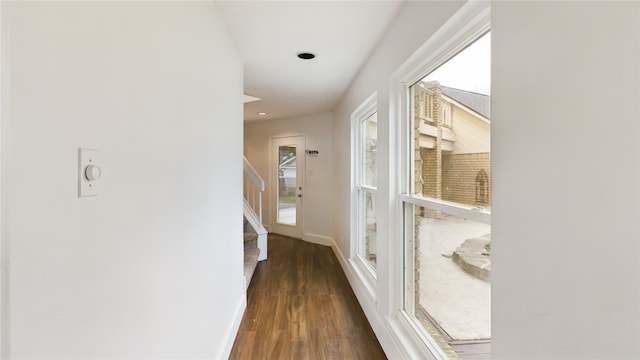 hallway with dark wood-style flooring, baseboards, recessed lighting, and stairs