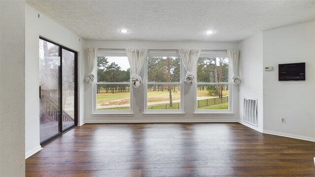 interior space with visible vents, baseboards, a textured ceiling, recessed lighting, and hardwood / wood-style floors