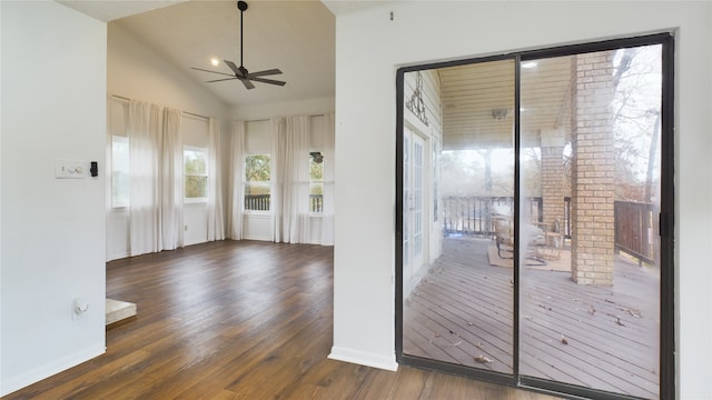 doorway featuring vaulted ceiling, ceiling fan, and dark wood-type flooring