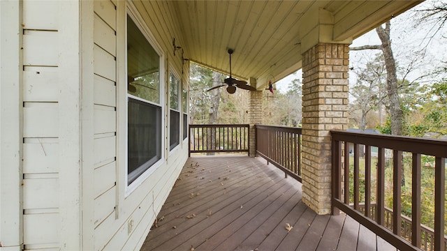 wooden deck featuring a porch and ceiling fan