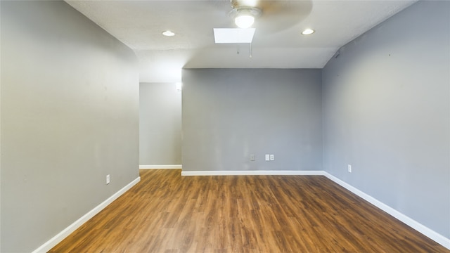 empty room featuring ceiling fan, dark hardwood / wood-style flooring, and lofted ceiling