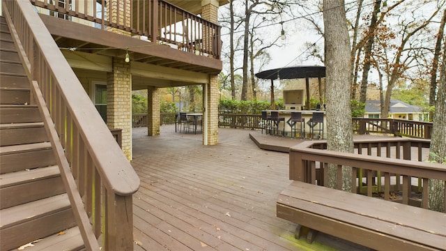 deck featuring exterior bar