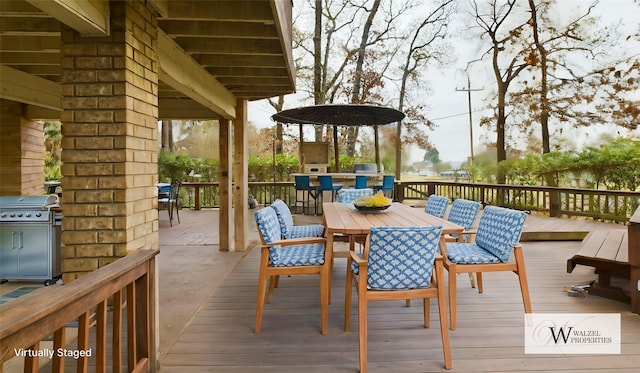 wooden terrace featuring outdoor dining space and a grill