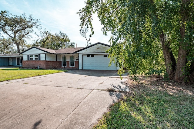 single story home featuring a front yard and a garage