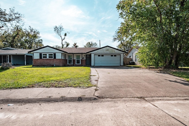 single story home featuring a front yard and a garage