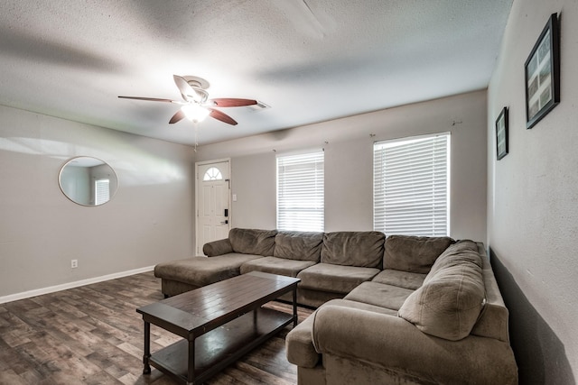 living room with ceiling fan, dark wood-type flooring, and a textured ceiling