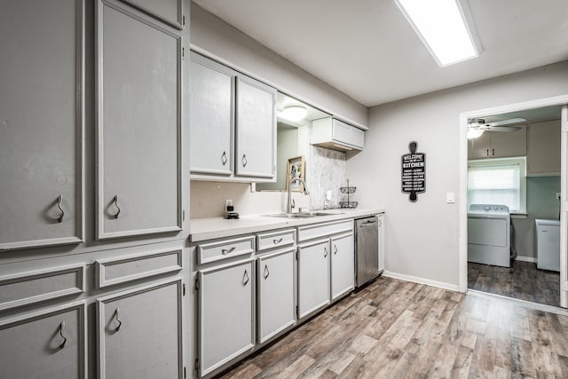 kitchen with ceiling fan, sink, dishwasher, washer / dryer, and light wood-type flooring