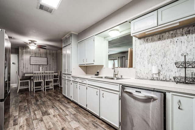 kitchen with sink, stainless steel dishwasher, ceiling fan, dark hardwood / wood-style flooring, and white cabinetry