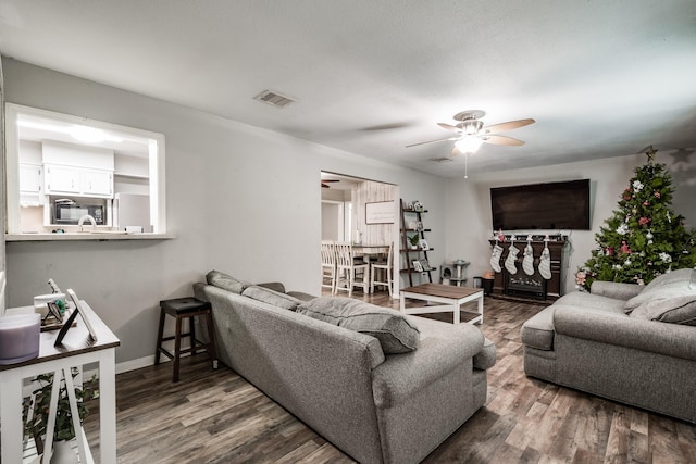 living room with hardwood / wood-style floors and ceiling fan