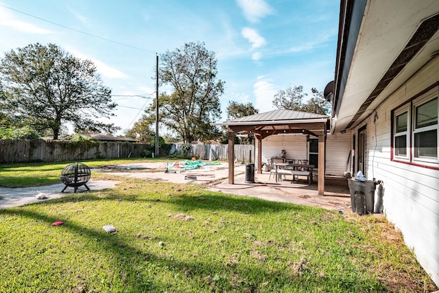 view of yard with a gazebo, a patio, and an outdoor fire pit