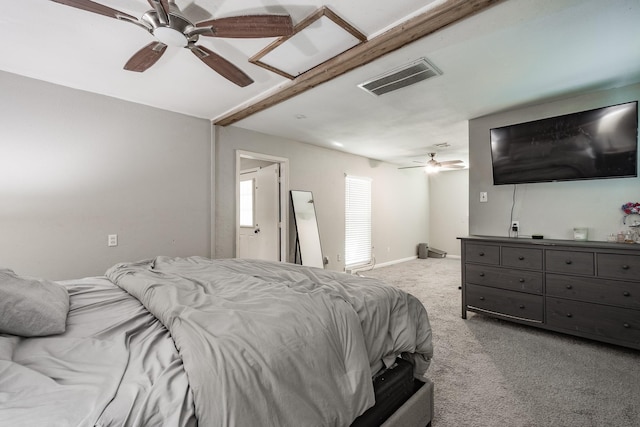 bedroom with beam ceiling, light colored carpet, and ceiling fan