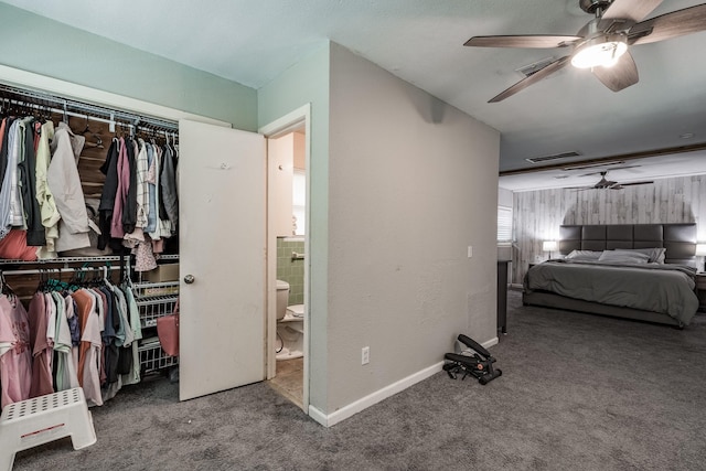 carpeted bedroom with ceiling fan and a closet