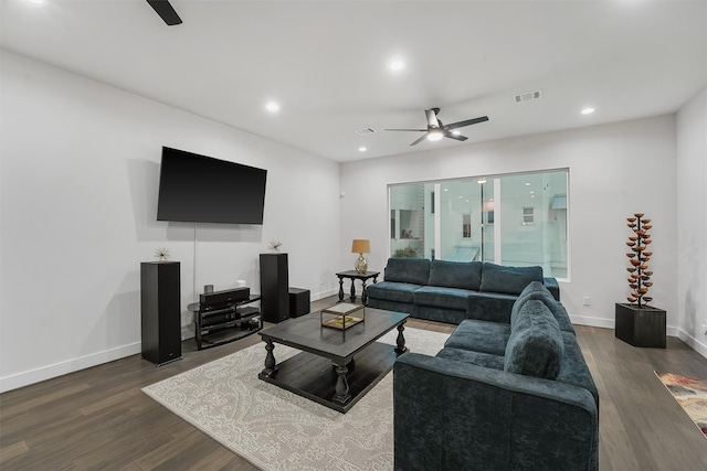 living room with ceiling fan and dark hardwood / wood-style flooring