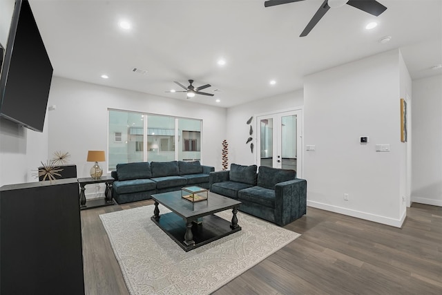 living room with dark hardwood / wood-style flooring and french doors