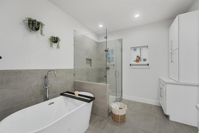 bathroom with tile patterned floors and independent shower and bath