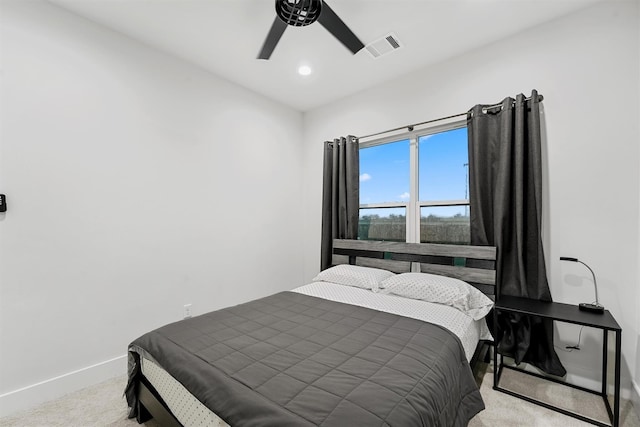 bedroom featuring ceiling fan and light carpet