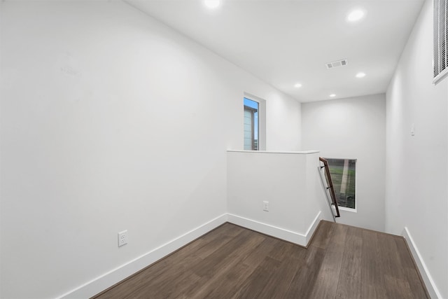 corridor with dark hardwood / wood-style flooring