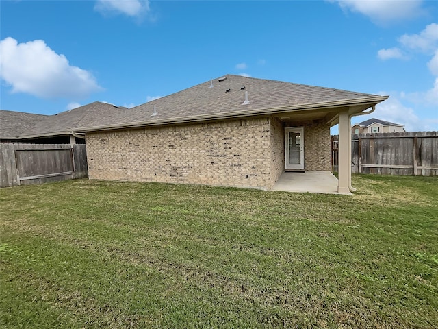 back of property featuring a patio and a lawn