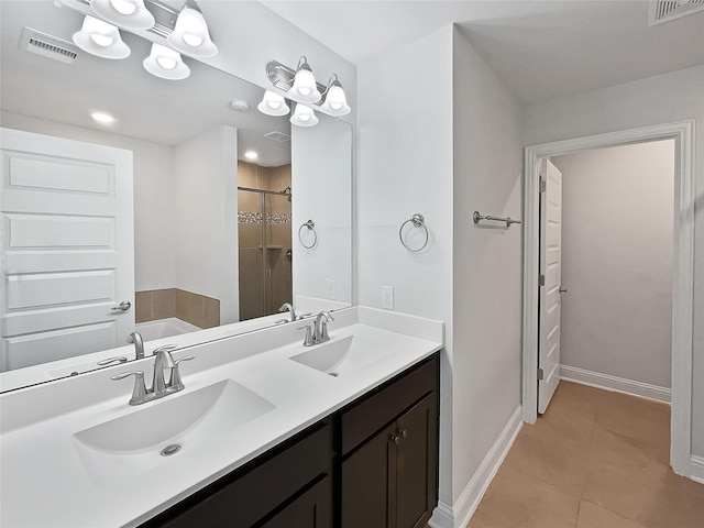 bathroom featuring tile patterned flooring, shower with separate bathtub, and vanity