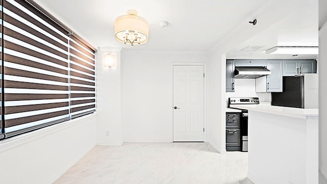 kitchen with appliances with stainless steel finishes, gray cabinets, extractor fan, and ornamental molding