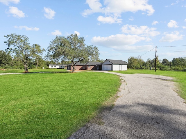 view of front of home featuring a garage and a front lawn