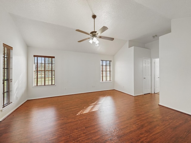 spare room with wood-type flooring, plenty of natural light, lofted ceiling, and ceiling fan