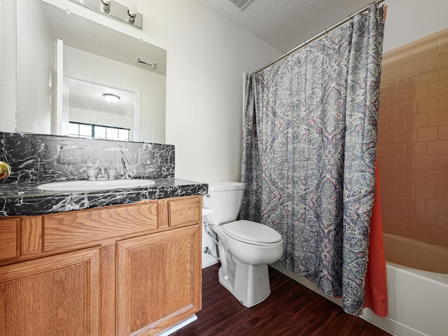 full bathroom with tasteful backsplash, vanity, a textured ceiling, wood-type flooring, and toilet