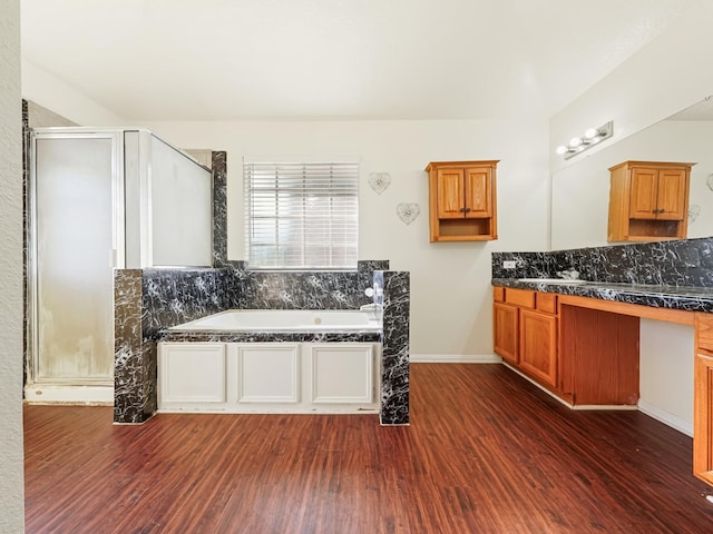 bathroom featuring hardwood / wood-style flooring, vanity, and shower with separate bathtub