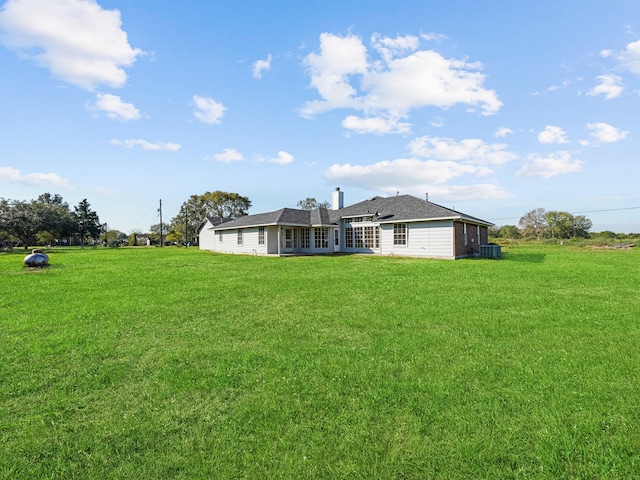 back of property featuring a yard and cooling unit