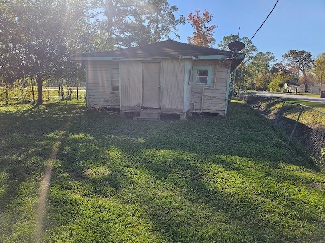 view of outdoor structure with a lawn