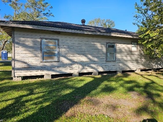 view of property exterior with a lawn