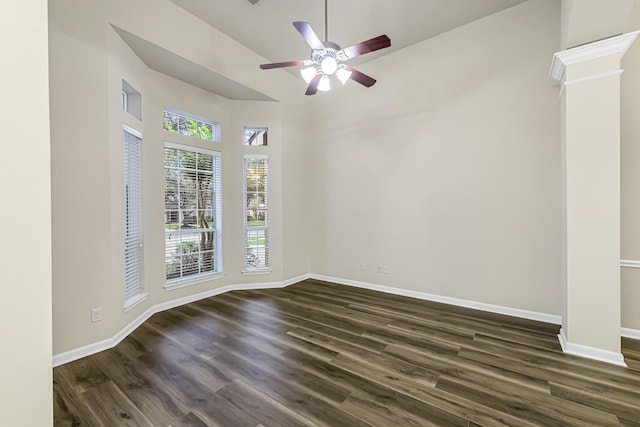 spare room with ceiling fan, dark hardwood / wood-style flooring, and a towering ceiling