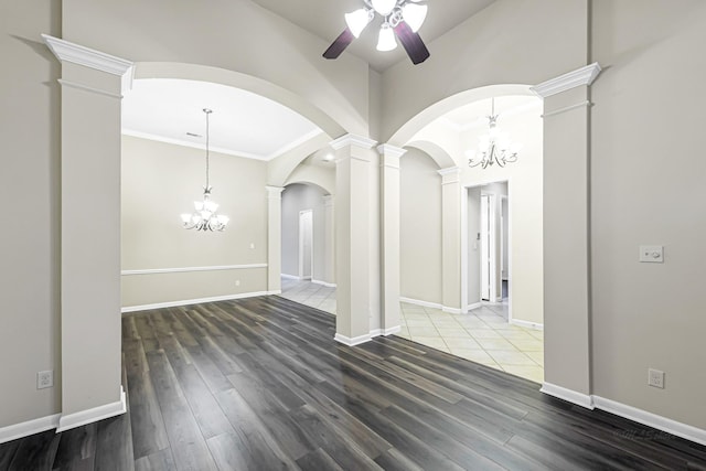 empty room featuring ceiling fan with notable chandelier, dark hardwood / wood-style floors, and crown molding