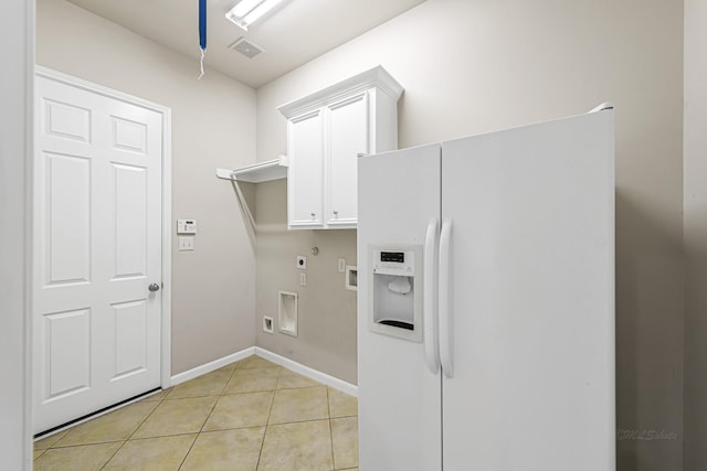 clothes washing area with hookup for an electric dryer, cabinets, washer hookup, gas dryer hookup, and light tile patterned floors